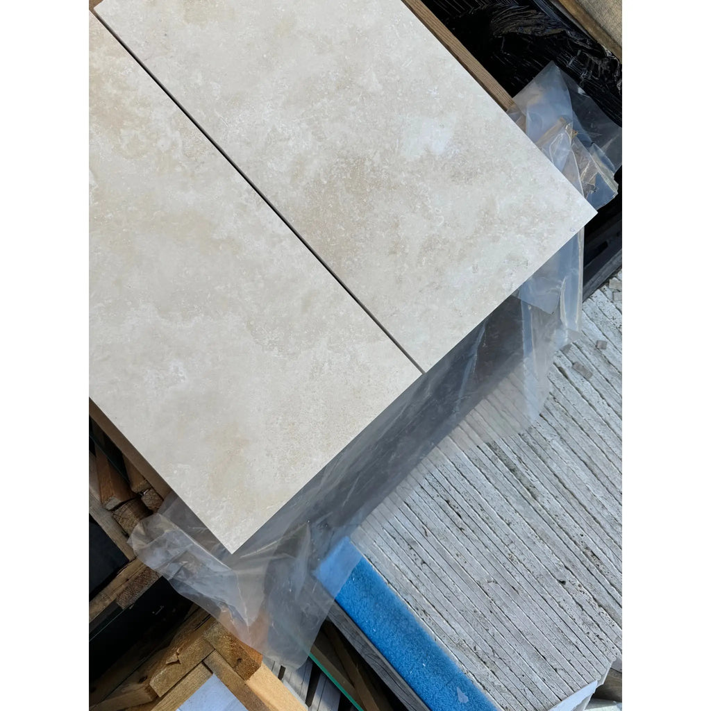 Light-colored textured tiles from Ivory Light Travertine 12X24 Cross-Cut collection