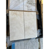 Two beige travertine stone tiles in Ivory Light Cross-Cut 12x24 Filled and Honed finish
