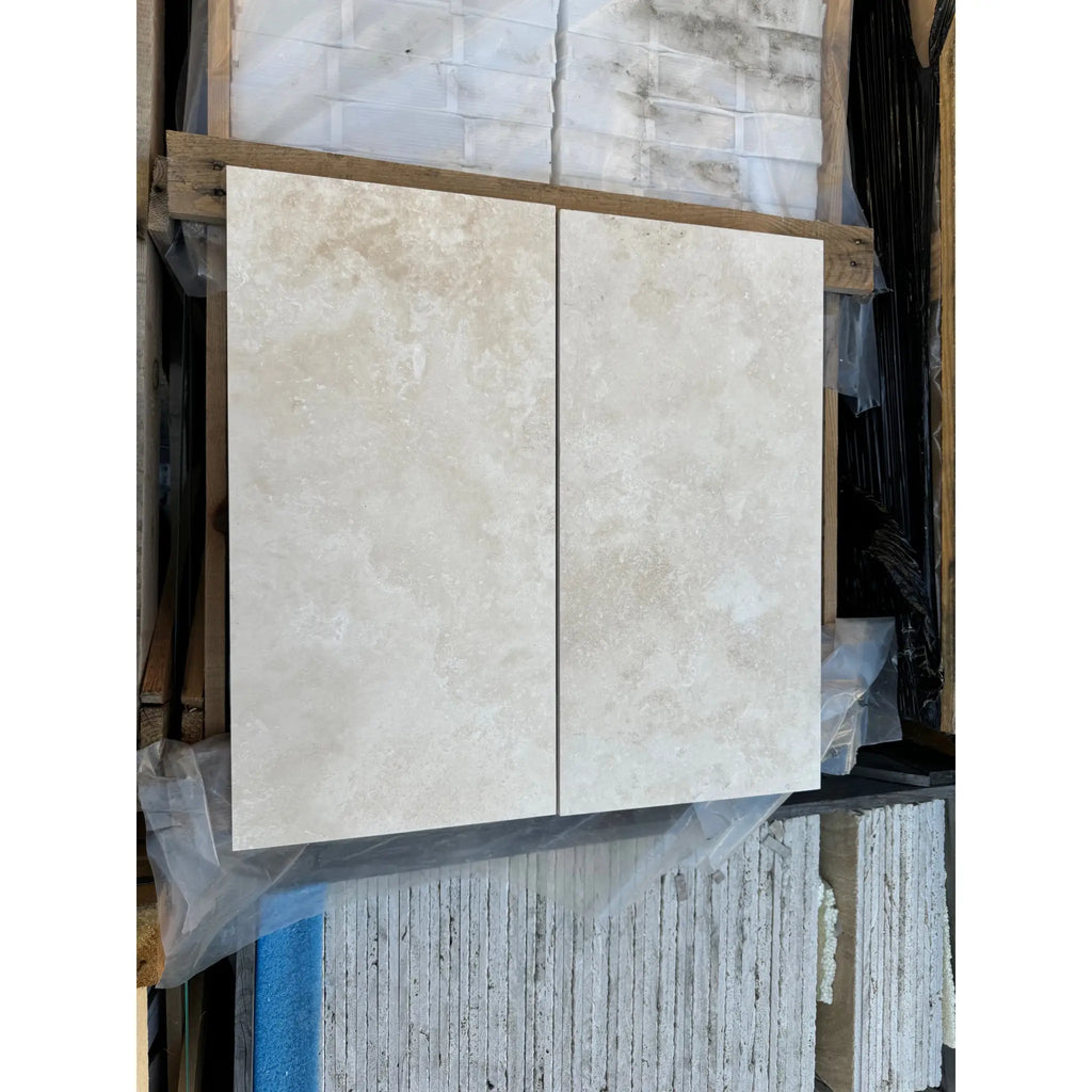 Two beige stone tiles from Ivory Light Travertine 12X24 Cross-Cut Filled and Honed product