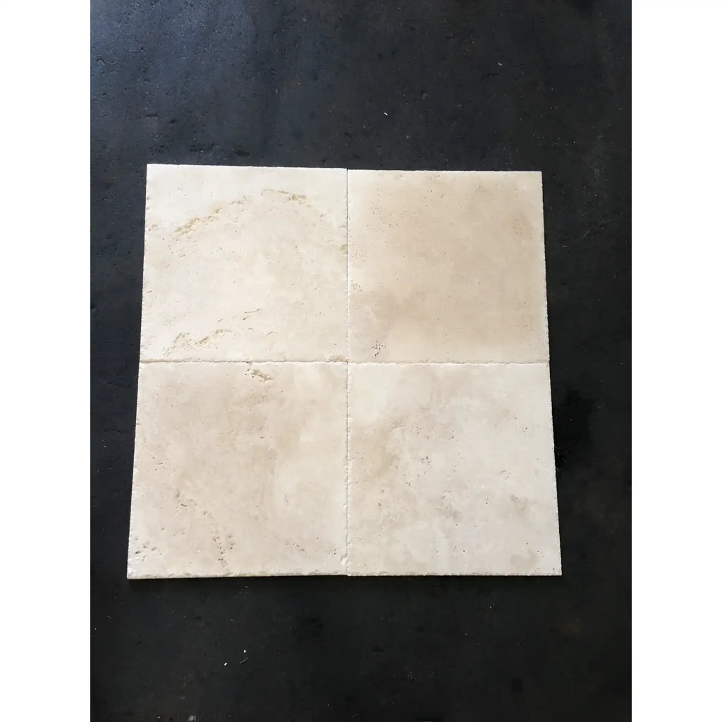 Four beige Ivory Travertine 12X24 vein-cut tiles, filled and polished, displayed together