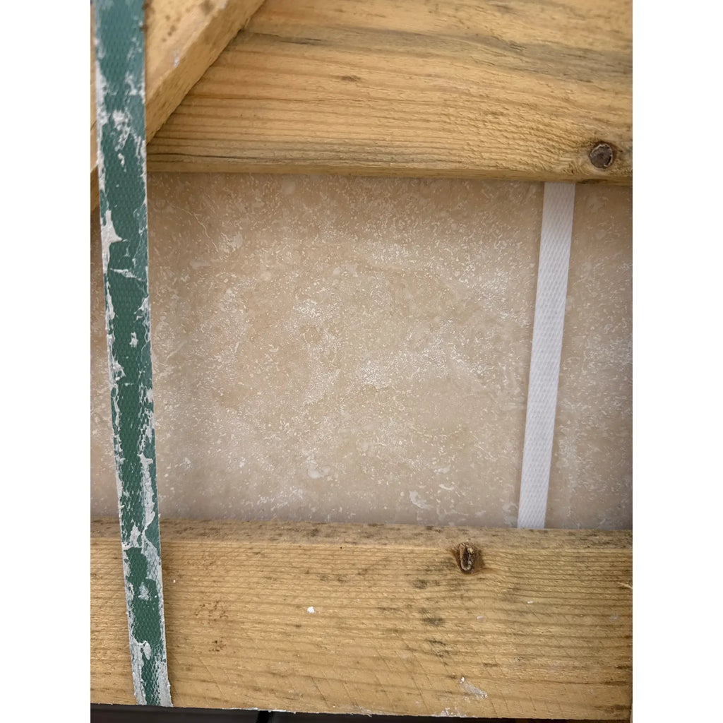 Wooden framed stone slab featuring Ivory Light Travertine 18X18 Cross-Cut Filled and Honed