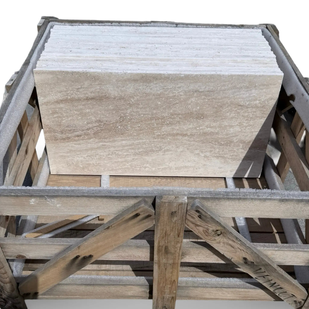 Stacked Ivory Light Travertine 18X36 Vein-Cut tiles in a wooden crate