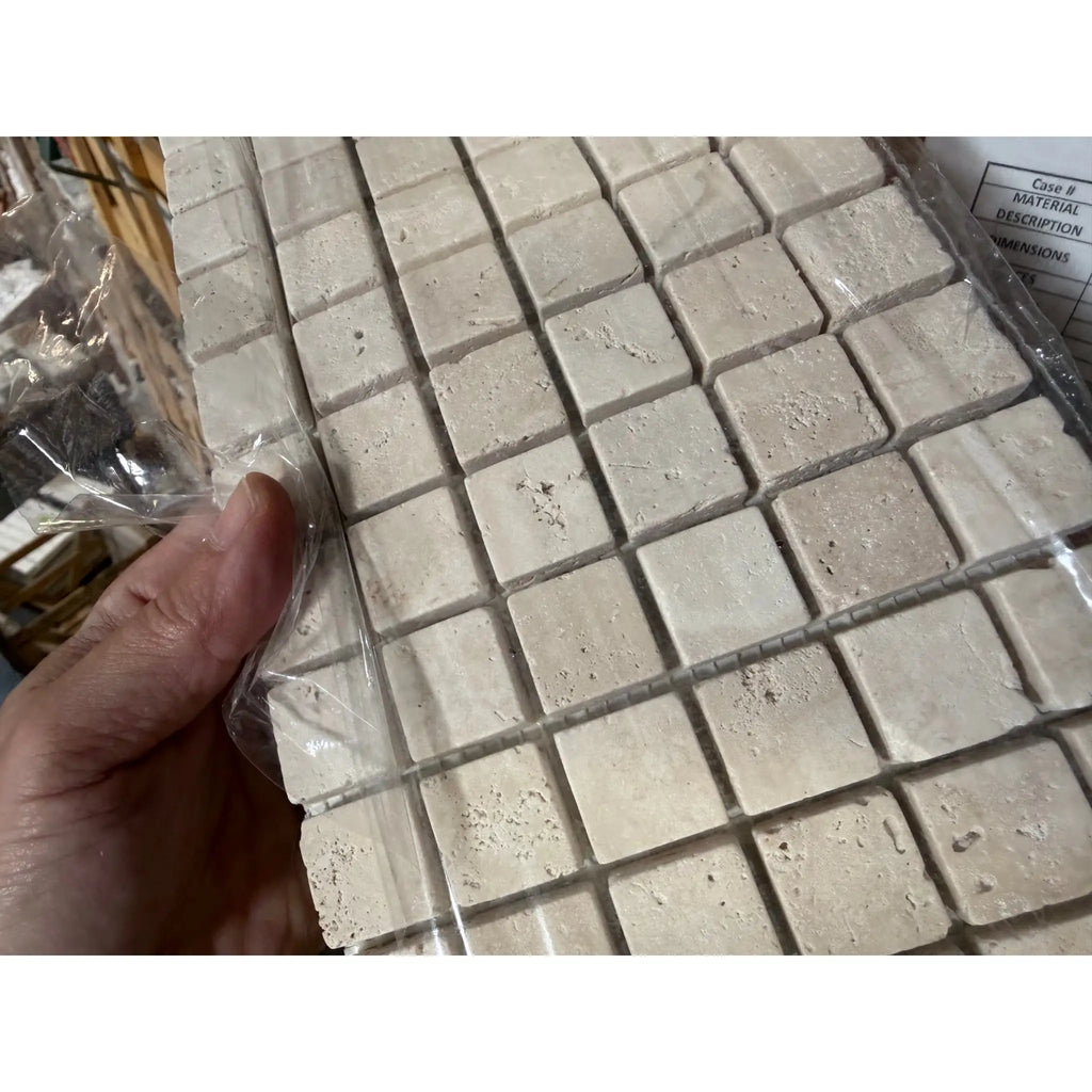 Ivory light travertine 1x1 tumbled mosaic tile sheet with beige natural stone texture