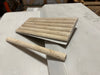 Beige travertine pencil liner and fluted border tiles for elegant bathroom or kitchen design
