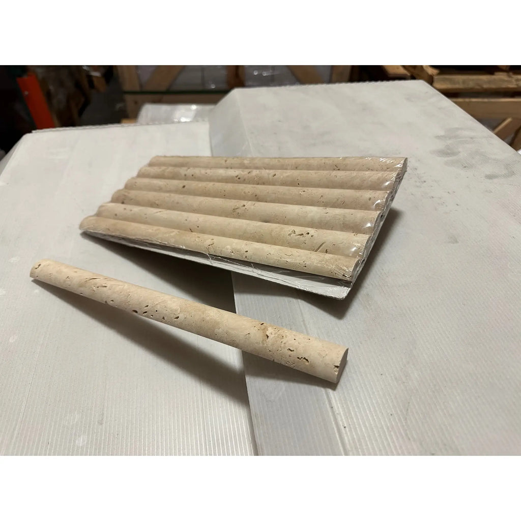 Beige travertine pencil liner and fluted border tiles for elegant bathroom or kitchen design
