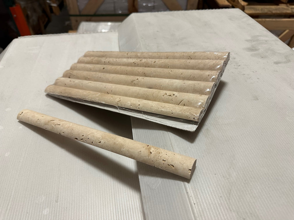 Beige travertine pencil liner and fluted border tiles for elegant bathroom or kitchen design