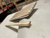 Light-colored textured travertine 1x6 quarter-round trim tile with rounded edge and speckled surface
