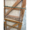 Rustic wooden crate with green straps securing Ivory Travertine 24x24 tiles