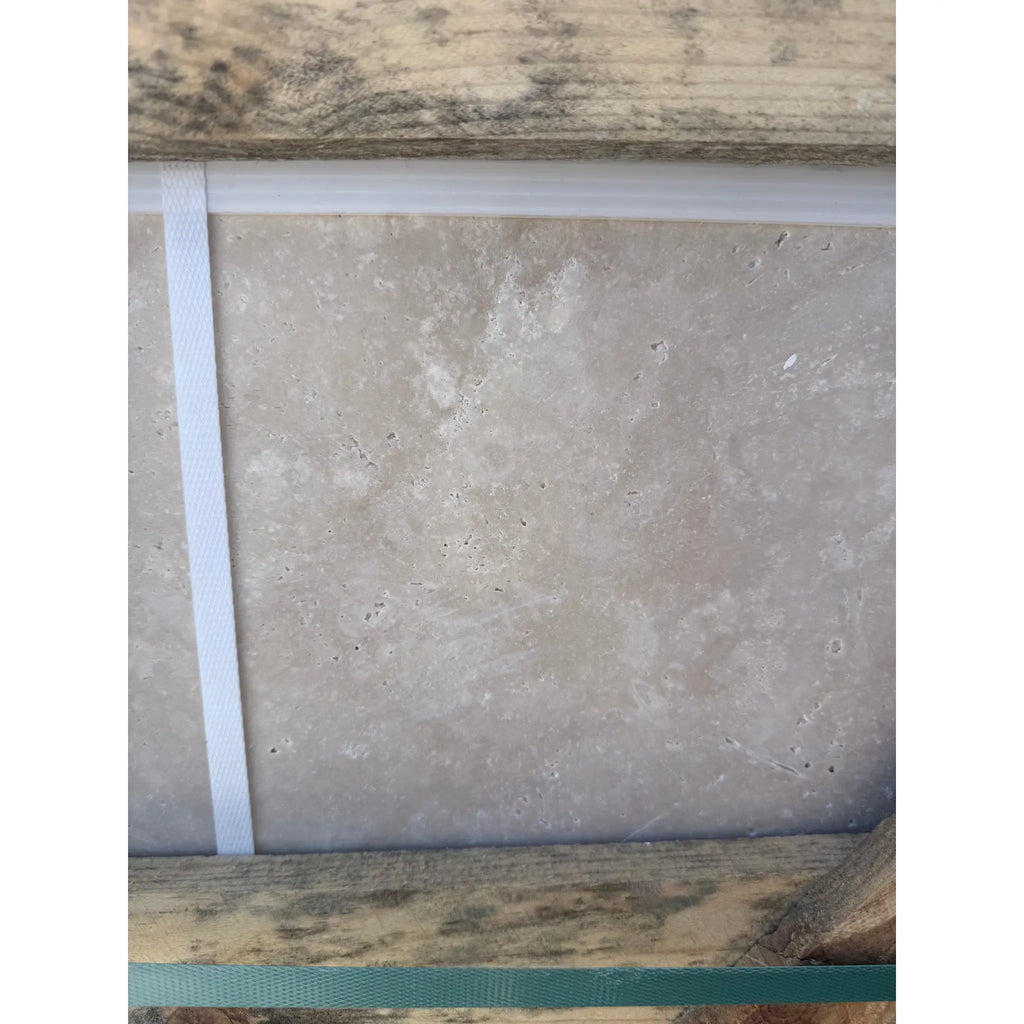 Light gray textured tile from Ivory Travertine 24x24 Cross-Cut Filled and Honed product