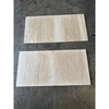 Two rectangular beige ivory light travertine tiles with natural stone veining 24x24 vein-cut filled and honed finish