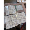 Beige ivory light travertine 2x2 mosaic tumbled stone tiles wrapped in clear plastic on wooden pallets