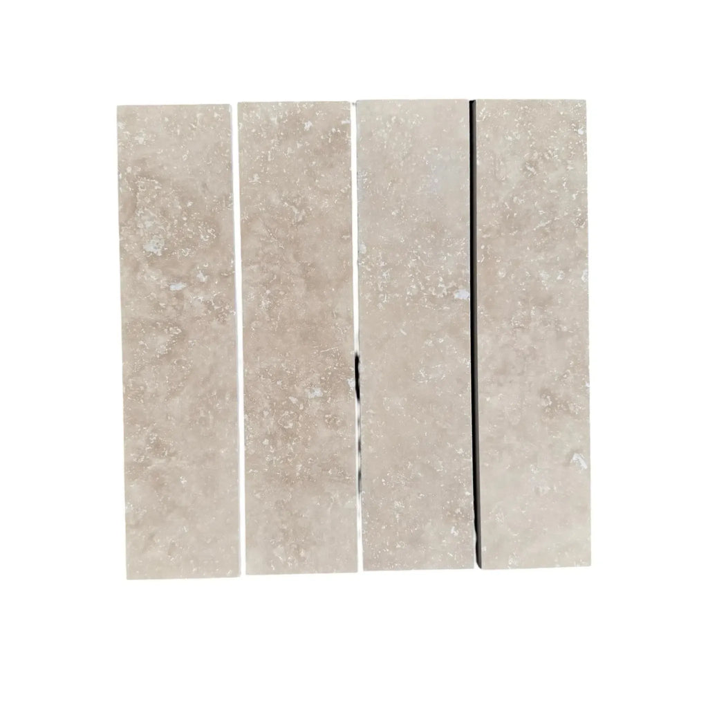 Four Ivory Light Travertine 3’’ X 12’’ Field Tiles displayed together