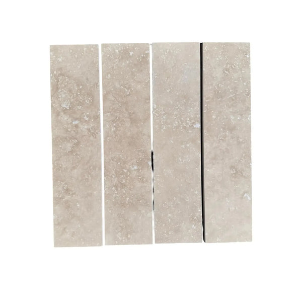 Four Ivory Light Travertine 3’’ X 12’’ Field Tiles displayed together