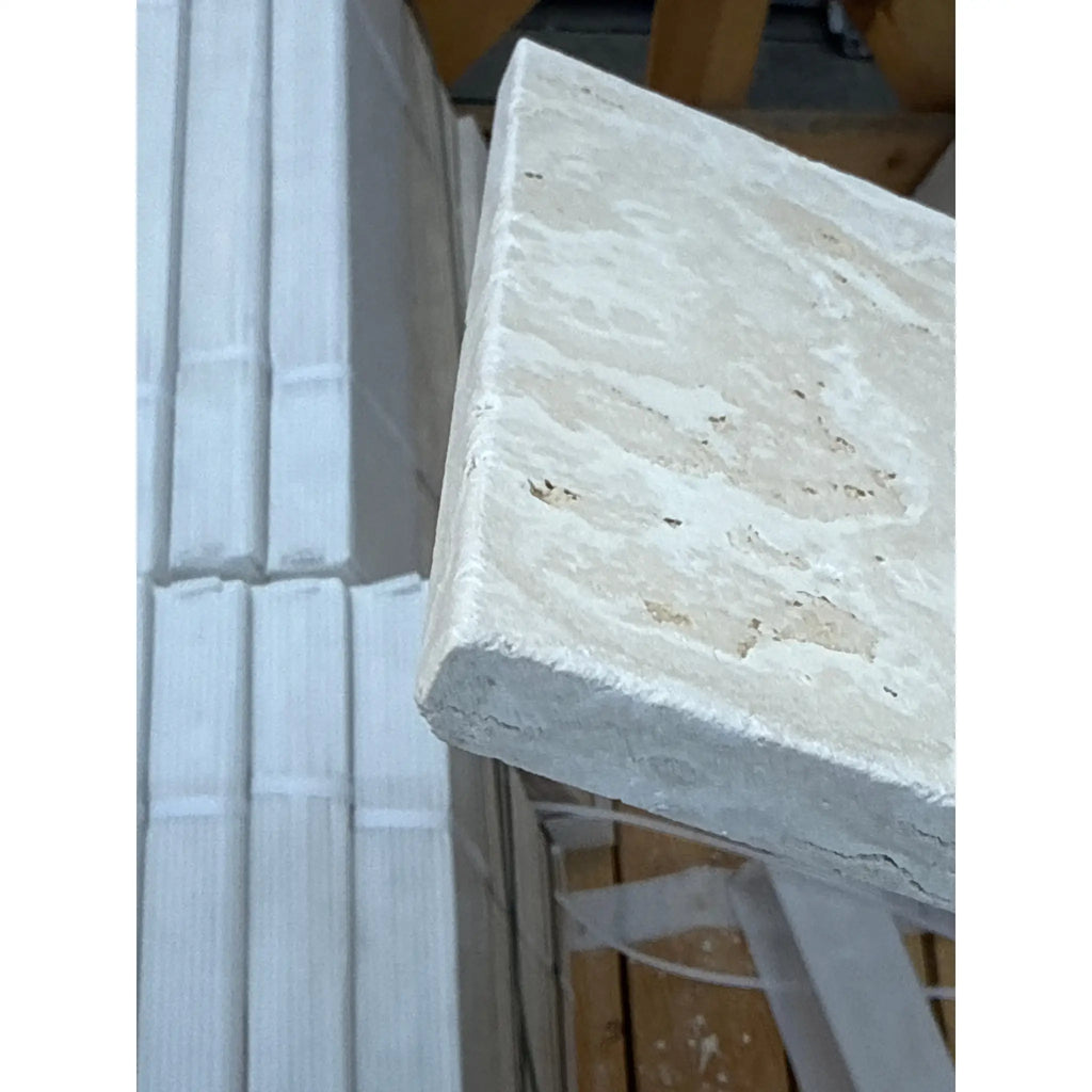 Textured off-white stone tile from Ivory Light Travertine Versailles Pattern Set