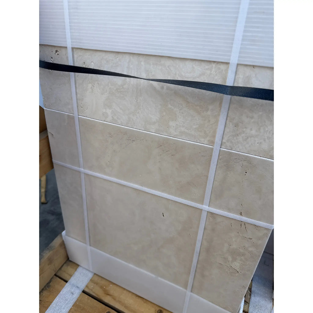 Tiled stone slabs of Ivory Travertine secured with straps in a Versailles pattern set