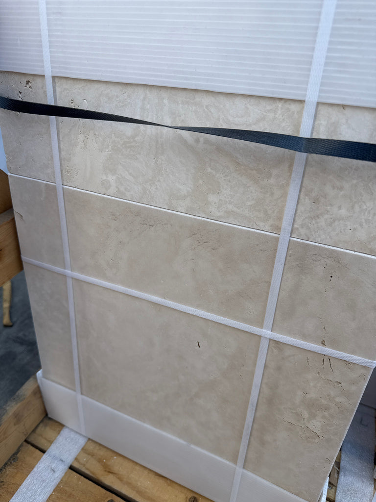 Tiled stone slabs of Ivory Travertine secured with straps in a Versailles pattern set