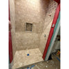 Ivory light travertine 4x4 cross-cut tumbled shower niche with blue accent tile
