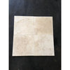Four beige Ivory Travertine 4X4 cross-cut tumbled tiles showcasing natural beauty