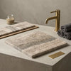 Beige and gray veined Roman silver travertine stone sink with matte finish featured in Legno D’Argento Striato vein-cut tile