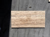 Legno D’Argento Striato Roman Silver Travertine 12x24 vein-cut tile with beige natural stone veining and polished surface