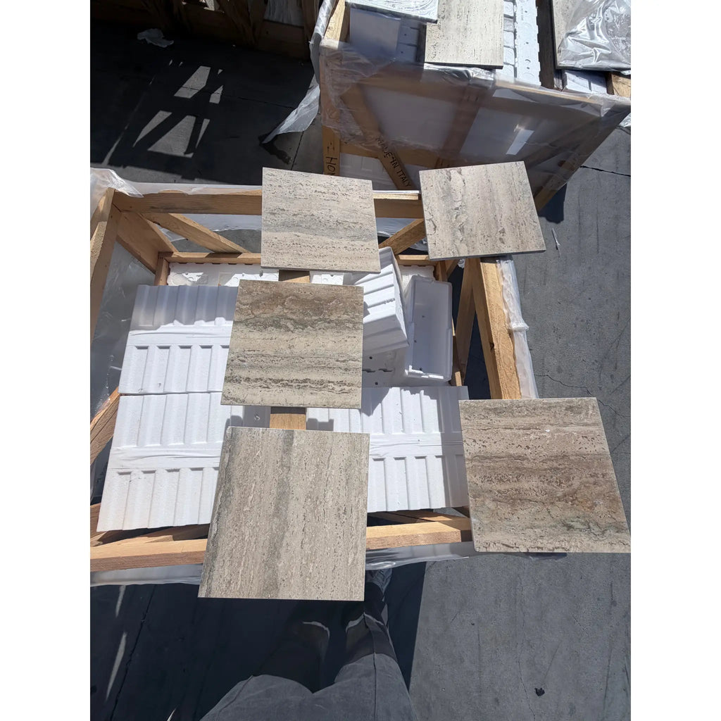 Beige and tan Roman Silver Travertine 12x24 vein-cut tiles on wooden pallets