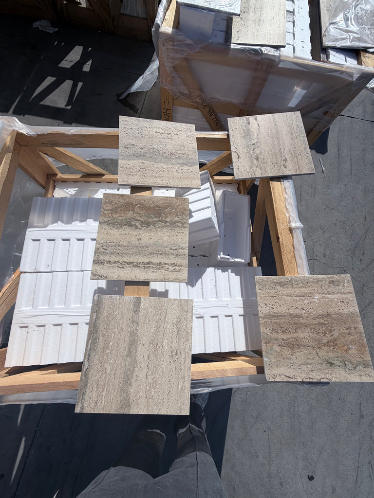 Beige and tan Roman Silver Travertine 12x24 vein-cut tiles on wooden pallets