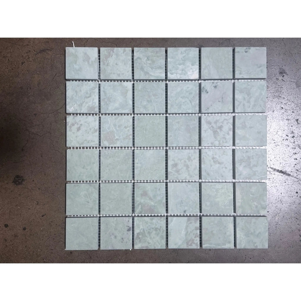 Gray marble mosaic tile panel with subtle veining, polished finish