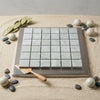 Square mosaic tile panel featuring light gray subtly veined marble tiles in a polished-honed finish with silver frame