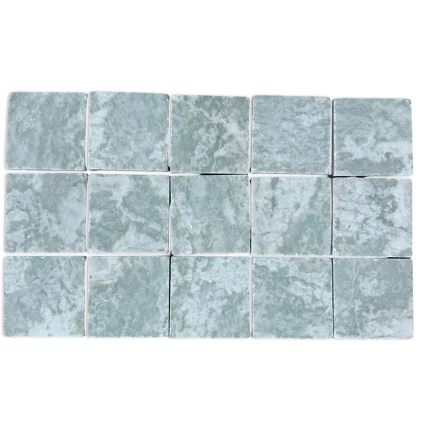 Grid of 15 pale green-grey Ming Green 3x3 tumbled stone tiles with subtle variegation