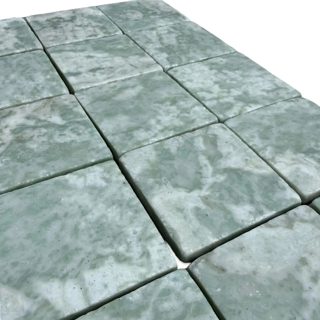 Square-cut Ming Green 3x3 tumbled marble tiles with natural veining for elegant flooring