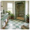 Green marble shower enclosure with arched frame and glass doors featuring ming green jade 12x12 polished marble tiles