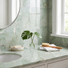 A sleek light green Ming Green 12x12 polished marble countertop with subtle veining and matching backsplash
