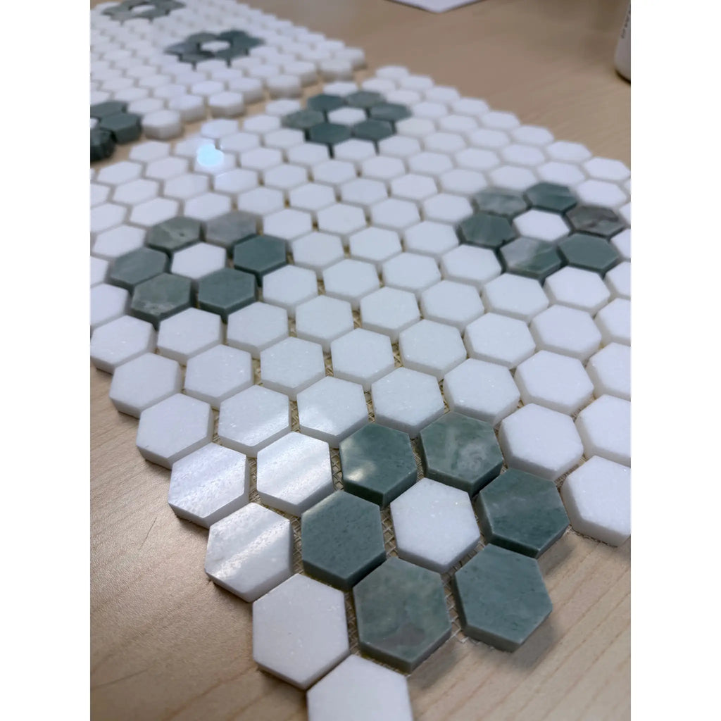 White and sage green hexagonal marble mosaic tiles arranged in a floral pattern from ming green jade green collection