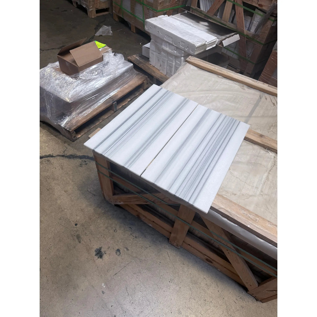 White marble tiles with prominent gray veining from Mink Marmara Equator Zebra Marble 12X12 Polished