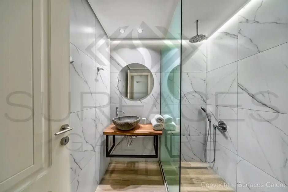 Installed marble and travertine tiles in kitchen, bathroom, shower, and living room, showcasing elegant and durable natural stone surfaces