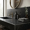 Black herringbone-patterned nero marquina marble mosaic countertop with integrated sink and matching backsplash
