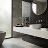 White ceramic vessel sink with sleek modern design paired with nero marquina black 1x3 herringbone marble mosaic
