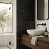 White ceramic bowl sink with sleek modern design paired with Nero Marquina black 2x2 marble mosaic polished tile