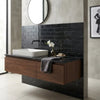 Modern floating vanity with dark wood finish and black marble countertop featuring nero marquina 2x4 brick mosaic