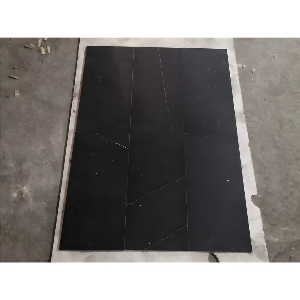 Black marble tiles with white veining in Nero Marquina Baseboard Trim Molding