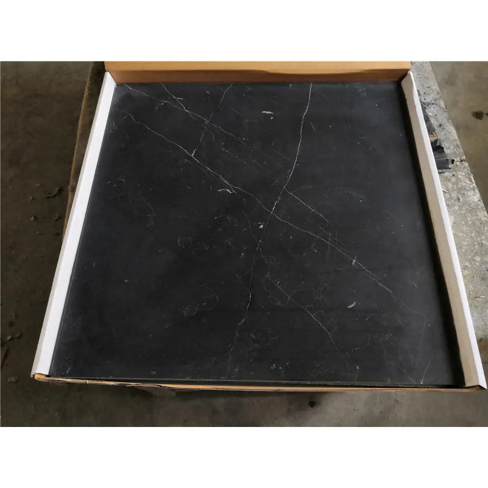 Black Nero Marquina marble coaster set with white veining in a cardboard box