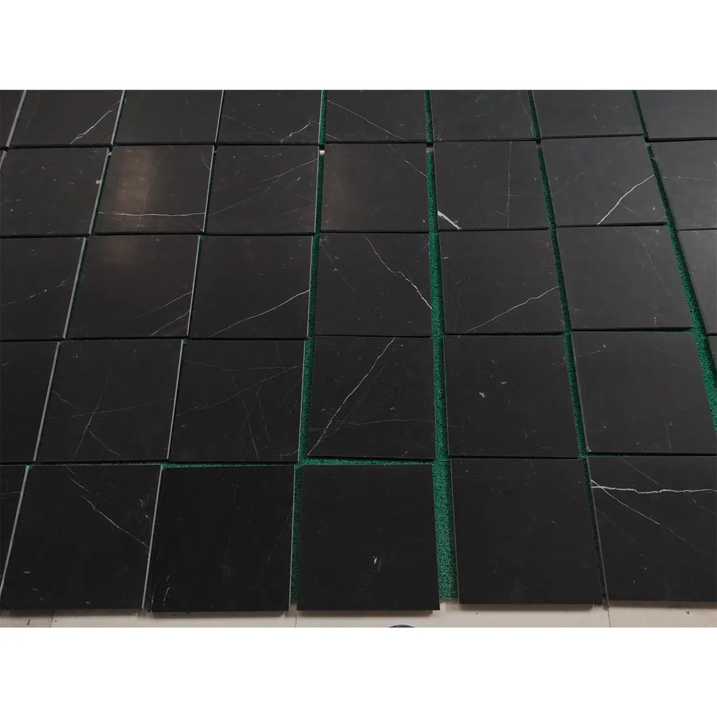 Black Nero Marquina marble coaster set with green edges and white veining