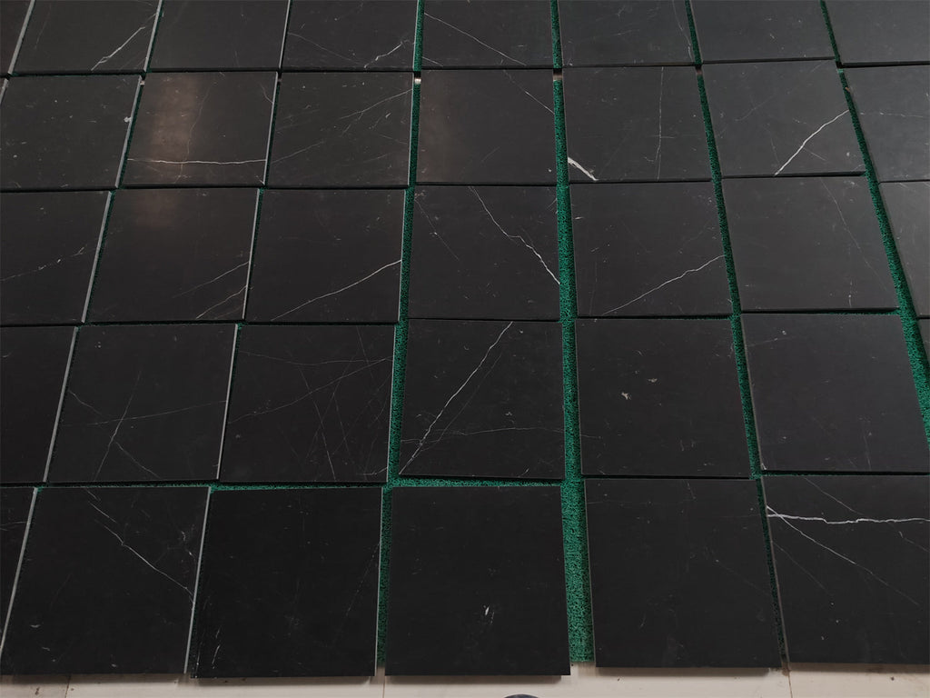 Black Nero Marquina marble coaster set with green edges and white veining