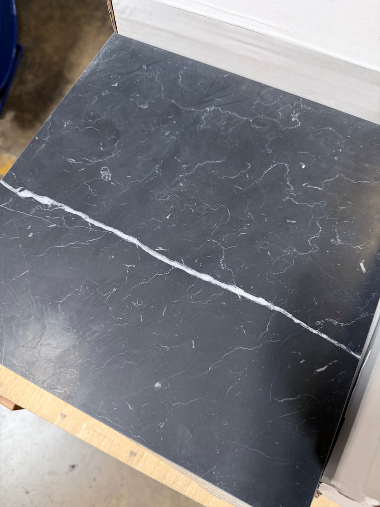 Black Nero Marquina marble tile with white veining and glossy finish 12x12