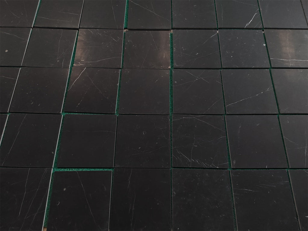 Black marble tile coaster set with green accents and white veining for Nero Marquina 12x12