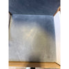 Silver metallic square coaster with textured surface and subtle shine