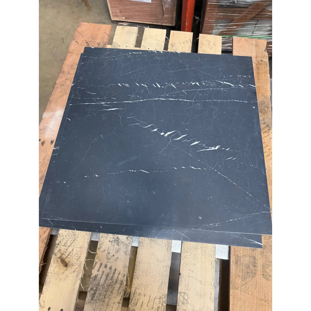 Dark gray nero marquina marble tile with subtle white veining 24x24 polished or honed finish
