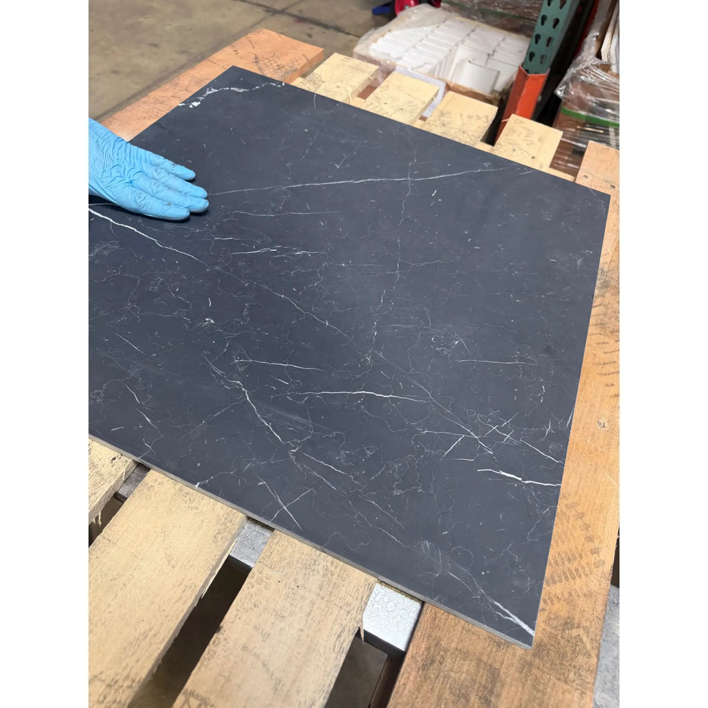 Dark gray nero marquina black marble tile with subtle white veining 24x24 polished or honed finish