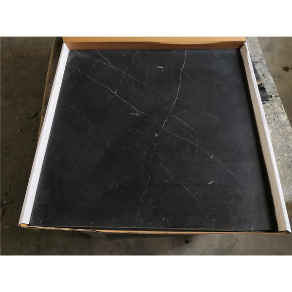 Black Nero Marquina marble coaster set with white veining in a cardboard box