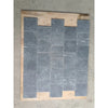 Dark gray rectangular nero marquina black marble 4x4 tumbled stone tiles with subtle white veining arranged in staggered pattern